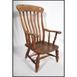 A 19th century Victorian beech and elm wood windsor chair / armchair. Raised on turned legs united
