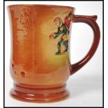 A Royal Doulton tankard having polychrome decoration in relief depicting Francis Drake playing bowls