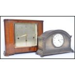 Two early 20th century clocks. One being a wooden cased clock with silvered dial with gilt faceted