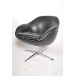 A 1960's black leather type egg swivel desk chair having a metal four point star base in the