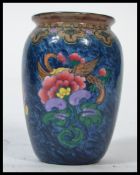 An early 20th century Losol Ware Magnolia pattern bulbous vase with blue glaze and magnolias to