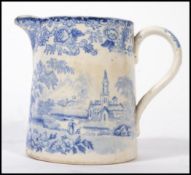 An 18th / 19th century blue and white Staffordshire creamer jug having unusual landscape