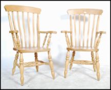 A pair of antique style beech wood Windsor style lathe back armchairs - chairs. Raised on turned