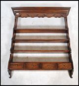 A good quality 18th century revival Ipswich oak hanging spice - plate rack having a shaped cornice