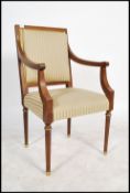 A 20th century mahogany French empire desk chair - armchair. Raised on turned legs with reeded