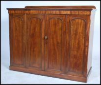A 19th century mahogany linen press cupboard - house keepers cupboard raised on plinth base with