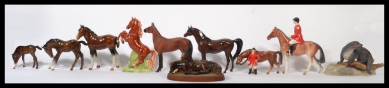 A group of Beswick and Royal Doulton horse figurines of various sized along with others (10) Tallest