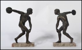 A pair of late 19th / early 20th century brown bronze cast figures of a classical discus throwers,