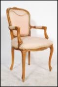 A 20th century French fauteil armchair of beech wood form. The reeded show wood frame with