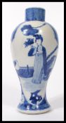 A 19th century blue and white Chinese vase decorated with a young maiden to each panel, peonies