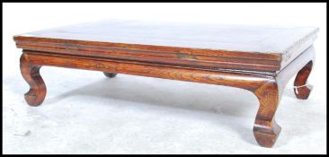 A 20th century Chinese elm kang table from Northern China with a solid elm top raisd on four horse