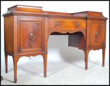 A Georgian 19th century mahogany drop centre pedestal sideboard being raised on square tapering legs