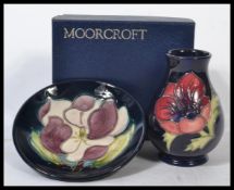 Two Moorcroft ceramic items to include a tubelined vase with blue ground and floral decoration and a