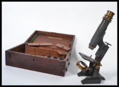 A 19th century travelling microscope in original fitted mahogany case containing extra lenses and