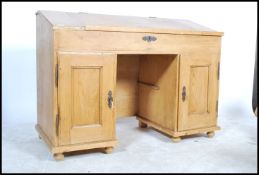 A 19th century Victorian twin pedestal scrubbed pine clerks desk, having a sloped hinged topan
