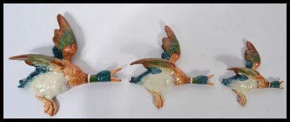 A set of three 20th century Beswick wall plaques in the form of graduating flying mallards  (