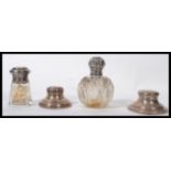 A collection of silver hallmarked items to include a silver topped cut glass perfume bottle, two