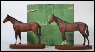 A pair of Royal Doulton horse figurines on wooden plinth bases. Both in matt grey one being boxed.