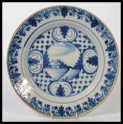 An early to mid 18th century Dutch Delft De Star pottery charger plate hand painted in blue and