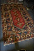 An oriental Oushak style rug with cental red and blue gounds with 4 medallions and decorative tree