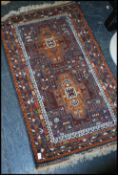 An oriental Tabriz wollen rug having twin medallions to the centre, decorative borders with