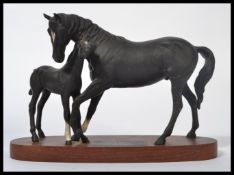 A Beswick model of 'Black Beauty & Foal' on wood base from the Connoisseur collection, measures