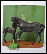 A boxed Royal Doulton figurine group of Black Beauty and Foal DA17 on wooden plinth with name