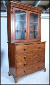 A 19th century solid mahogany secretaire bureau bookcase - chest of drawers being raised on