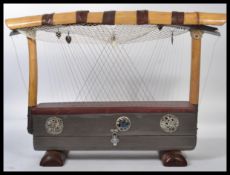 A vintage 20th century Chinese harp musical instrument with bamboo top with silvered medallions