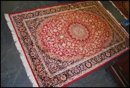 A large Iranian / Persian Keshan carpet - rug having red ground with geometric decoration and