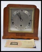 An mahogany cased eight day lever Elliot mantel clock having silvered dial with Roman numerals,
