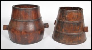 A pair of vintage early 20th century near matching Chinese coopered barrels, each barrel fitted with