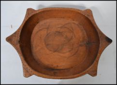 A large antique Ethnic carved wooden serving bowl having good patination. Measures 56cms wide.