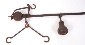 An early 20th century cast iron Potato weigher set of scales complete with the weight and hooks