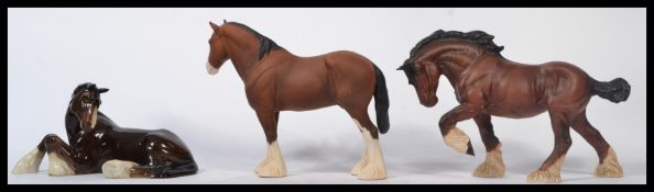 A group of three Royal Doulton and Beswick shire horses to include a standing Beswick Ware horse a