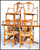 A regency style yew wood pedestal dining table together with a set of Hepplewhite style dining