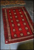 A good quality Ikea Persisk Belutch handwoven wollen rug having central design of medallions to