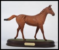 A Beswick figurine of a horse Lammtarra on oval plinth base. Measures 22cms high. Appears in good