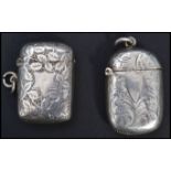 Two silver hallmarked match Vesta case having a fitted hinged lids, chase decorated with foliate