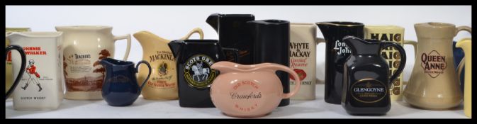 A collection of advertising point of  sale water / whisky jugs to include J & B Whisky, The