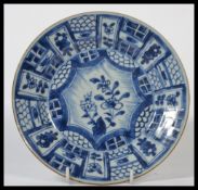 An early 18th century Chinese blue and white Kraak plate hand painted with central star cartouche