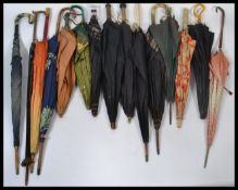 A good group of vintage early 20th century Edwardian umbrellas / parasols to include palm wood,