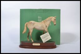 A Royal Doulton horse `Desert Orchid` style two, model No. DA184, light grey matt, 19.7cm high on