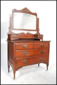 An Edwardian mahogany dressing table chest being r