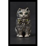 A sterling silver miniature figurine of a cat having emerald inset eyes. Weighs 17 grams.