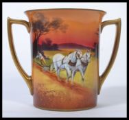 A Royal Doulton twin handled loving cup hand painted in a horse and plough / God speed the plough
