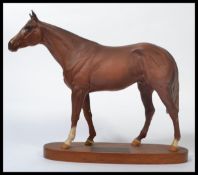 A Beswick connoisseur model Grundy racehorse of the year 1975, matt chestnut on wooden plinth.