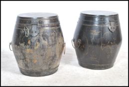 A pair of matching early to mid 20th century Chinese wooden lacquered storage barrels, each fitted