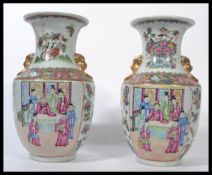 A near pair of Oriental Chinese ceramic vases one being an 18th century example with famille rose