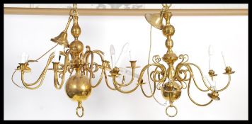 A contemporary pair of 19th century style brass six branch chandelier, with foliate sconce arms.